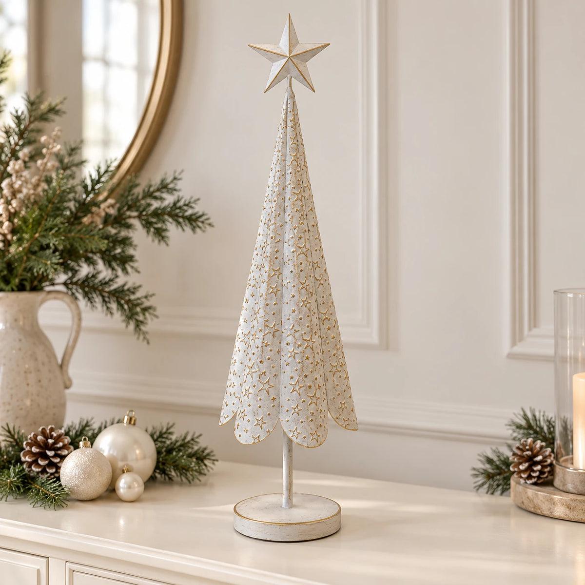 Large white metal Christmas tree with gold stars styled on a neutral sideboard