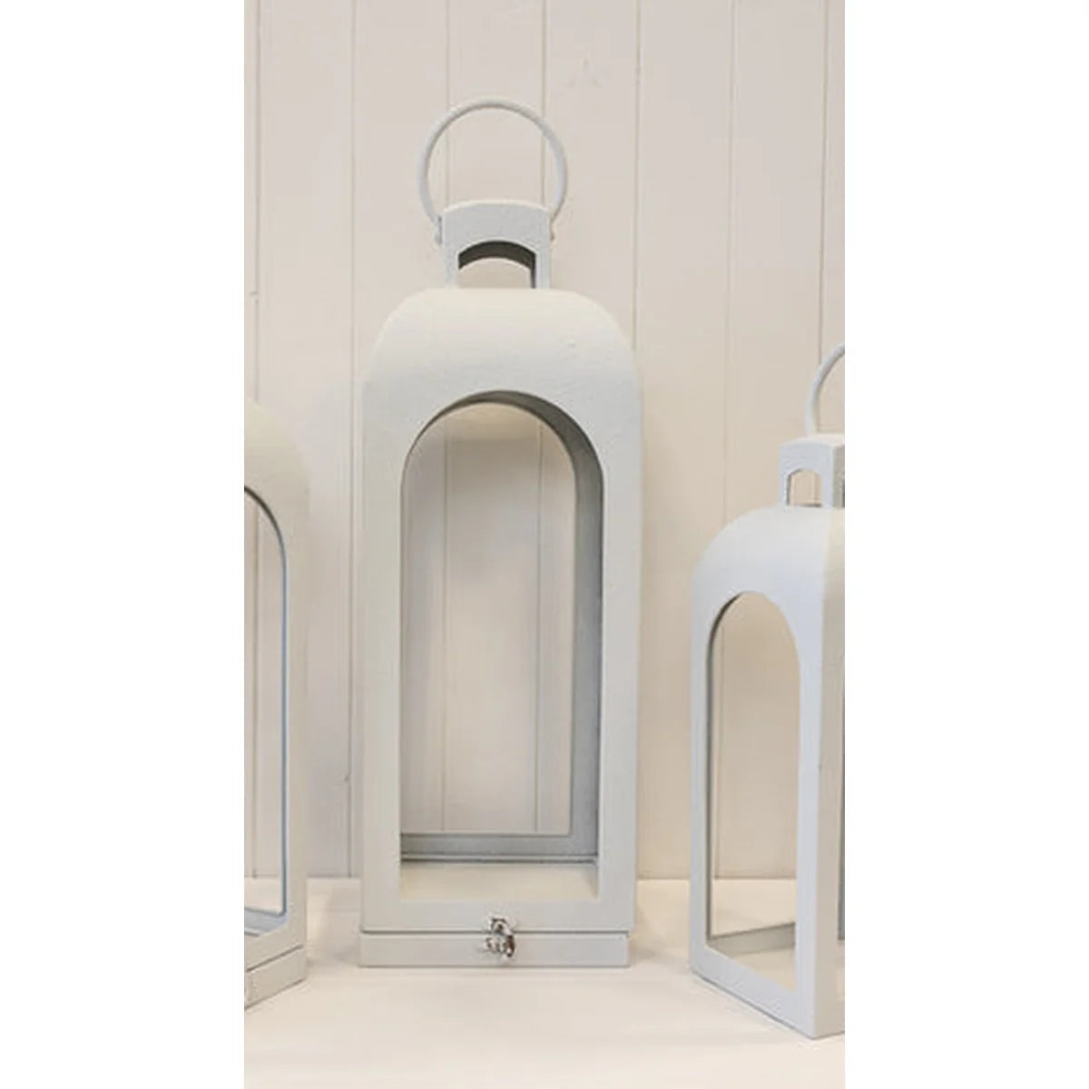 Close detail of off-white lantern arched sides and rounded ring handle