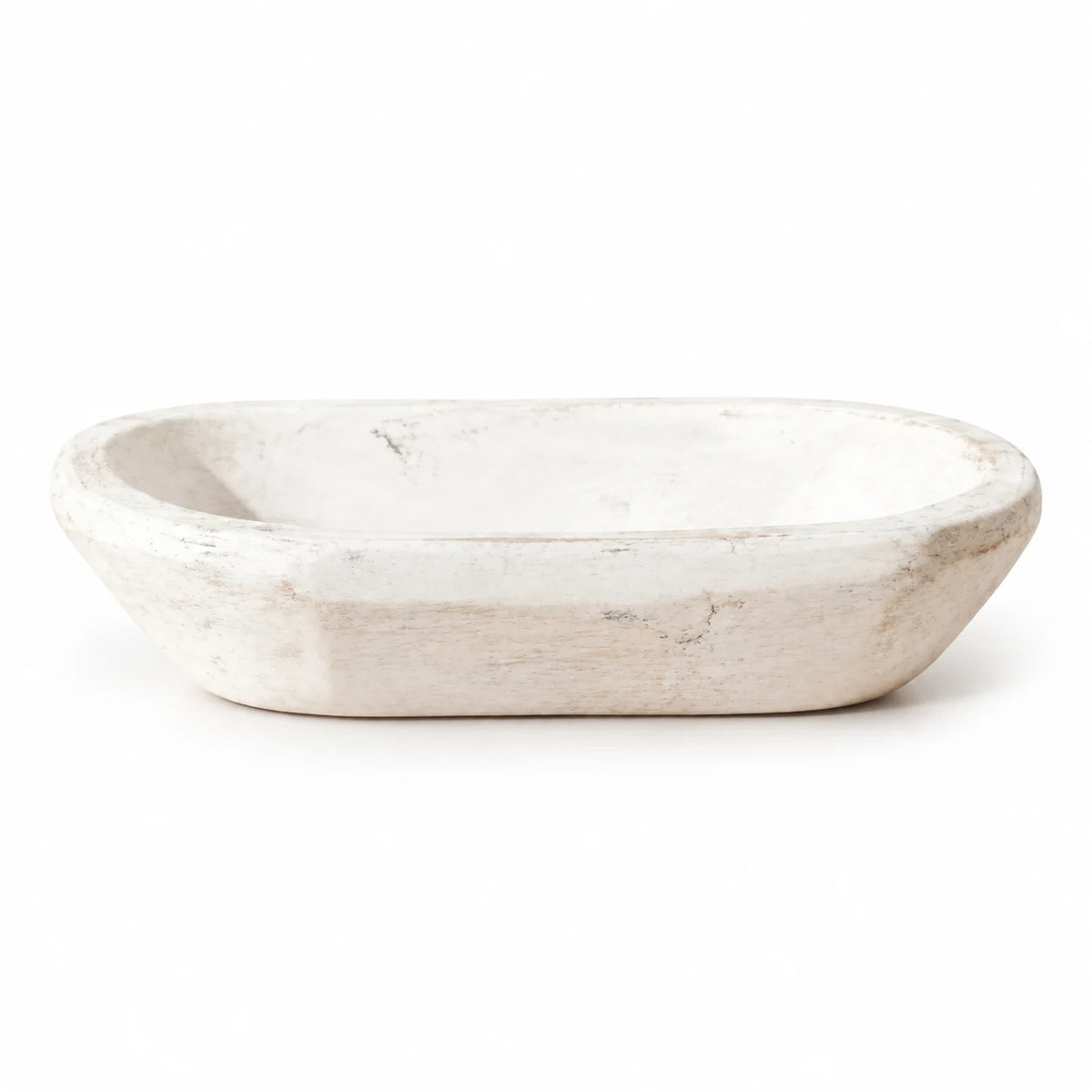 White rustic wooden mini dough bowl with a shallow oval basin and gently worn finish, shown alone on white.