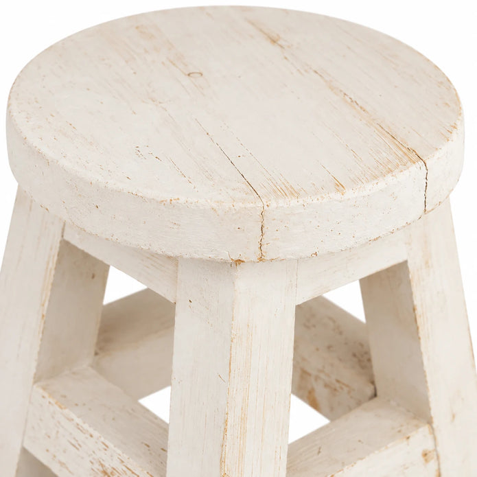 Close-up of the white mini stool’s round top and rim, showing painted grain and fine surface cracks.