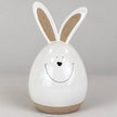 Detail view of the white ceramic rabbit showing its smiling face and beige inner ears.
