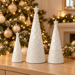 Small, medium and large white scalloped glazed ceramic Christmas trees with sparkling Christmas lights; sold separately