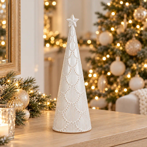 White scalloped glazed ceramic Christmas tree by Satchville, medium size, decorated with festive holiday ornaments.
