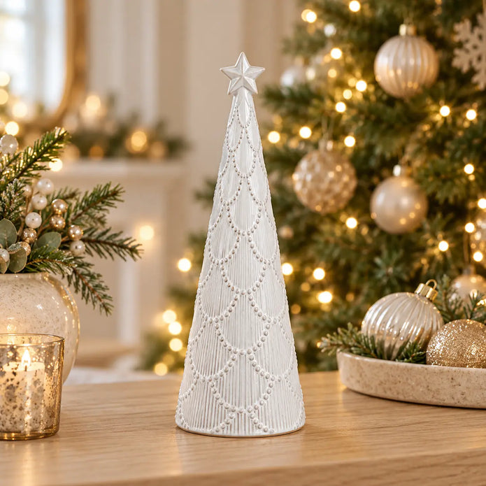 Small white scalloped glazed ceramic Christmas tree by Satchville, featuring festive holiday design on a lifestyle console setting.