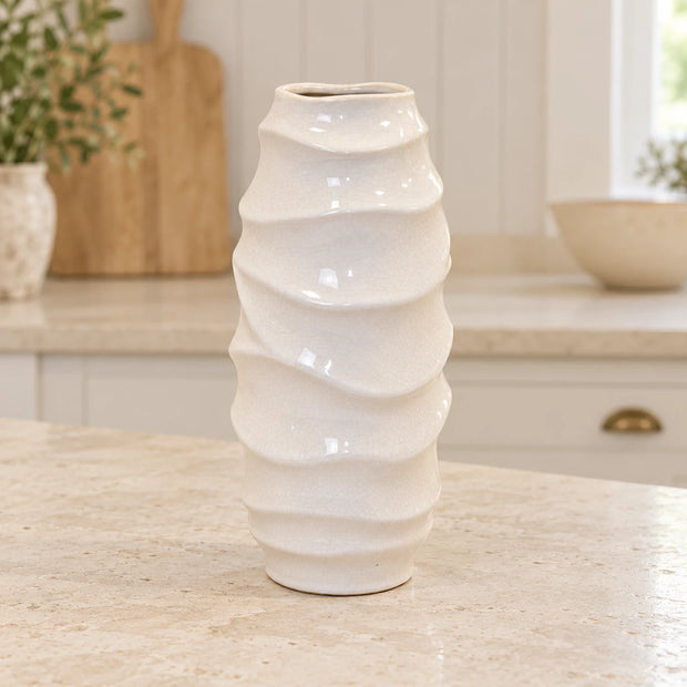 White ceramic vase with sculpted wave design from Satchville, standing 31cm tall, ideal for kitchen or decorative use.