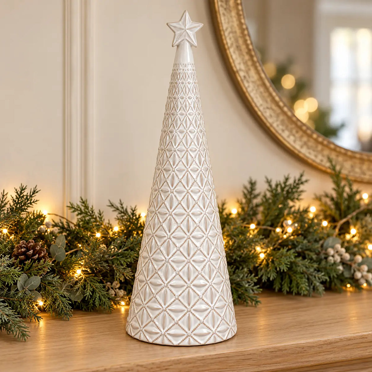 large white star glazed ceramic Christmas tree in a festive setting with warm sparkling Christmas lights