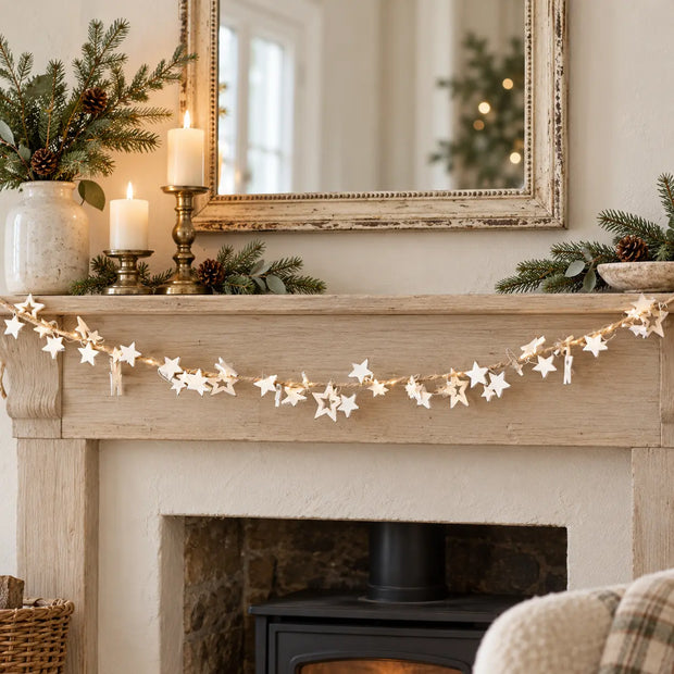 White Star LED Christmas garland by Satchville, featuring illuminated white star decorations for festive mantel decor.