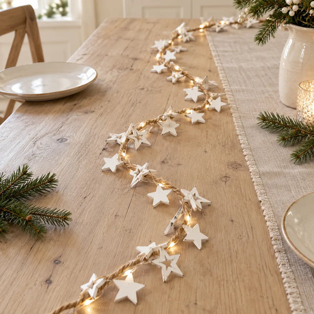 White Star LED Christmas garland by Satchville with glowing star lights, ideal for holiday table decorations.