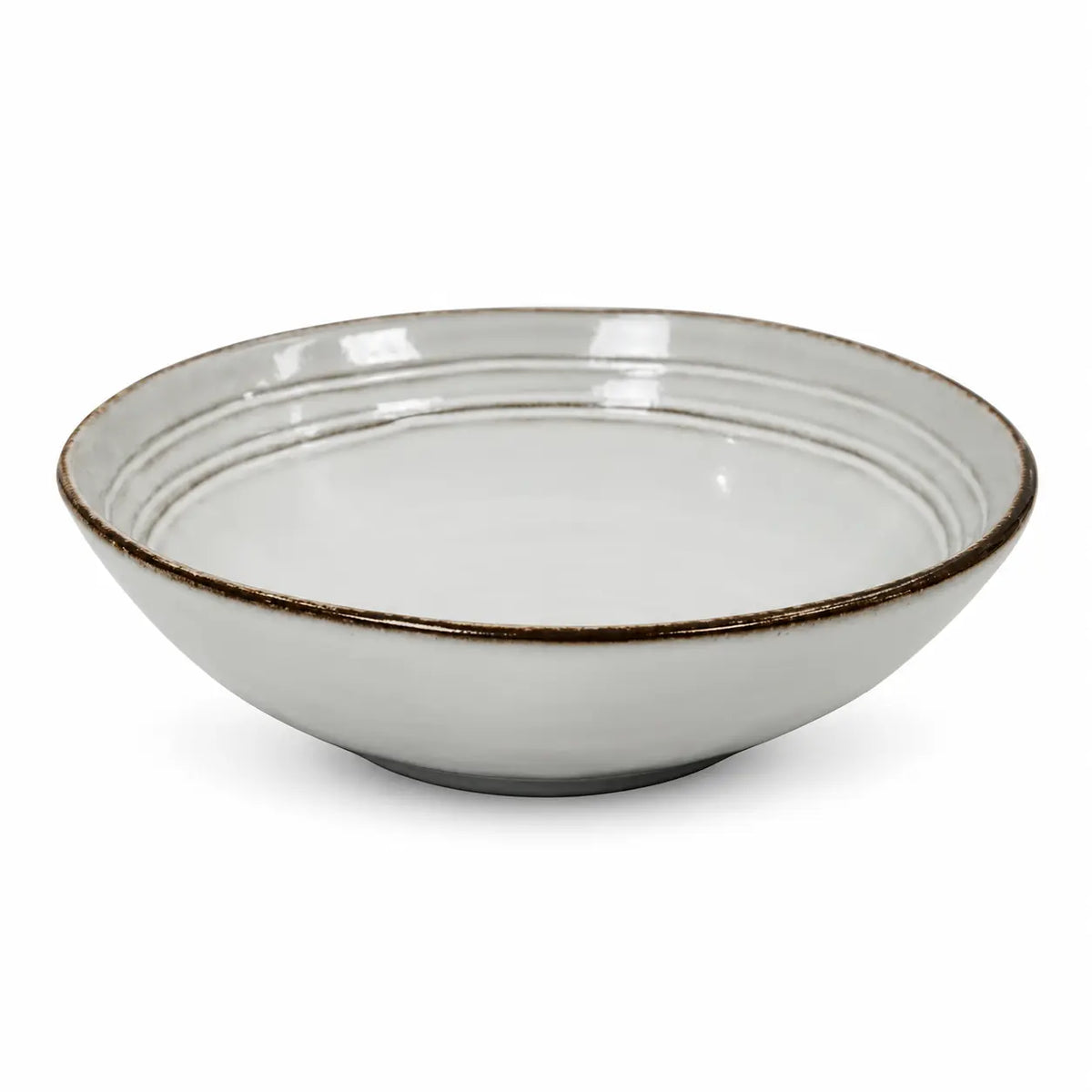 White stoneware pasta bowl with dark brown rim isolated on a white background