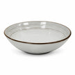 White stoneware pasta bowl with dark brown rim isolated on a white background