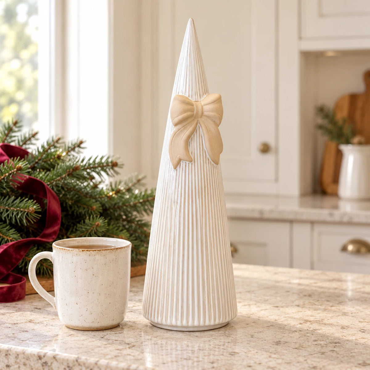 Satchville large white stoneglazed striped Christmas tree with decorative bow on a kitchen scale