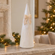 Large Satchville white stoneglazed striped Christmas tree with decorative bow on mantelpiece