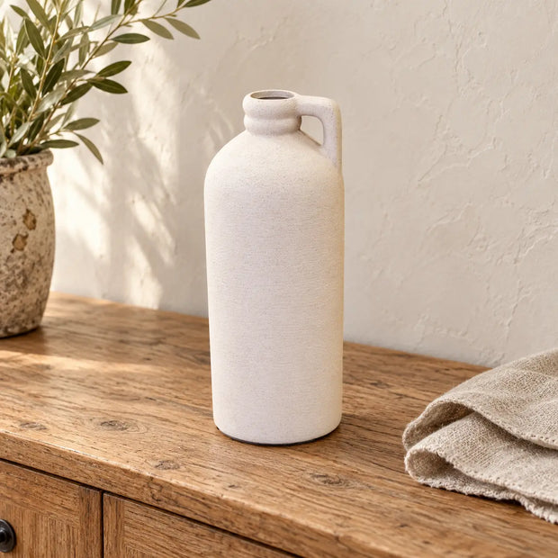 White tall textured bottle vase by Satchville, featuring a sleek design and artistic surface for decorative floral arrangements.