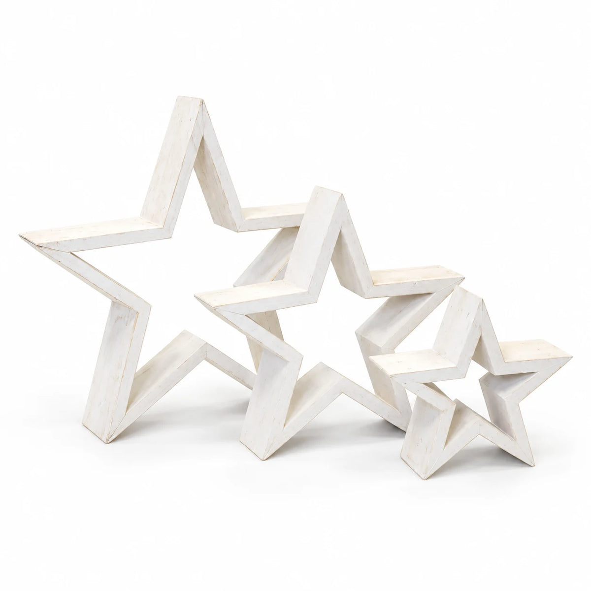 Set of three whitewashed wooden outline stars on a white studio background