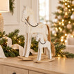 Small and large whitewashed wooden rocking horses styled together for Christmas, sold individually