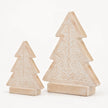 Two sizes of carved whitewashed wooden Christmas trees on a pale background