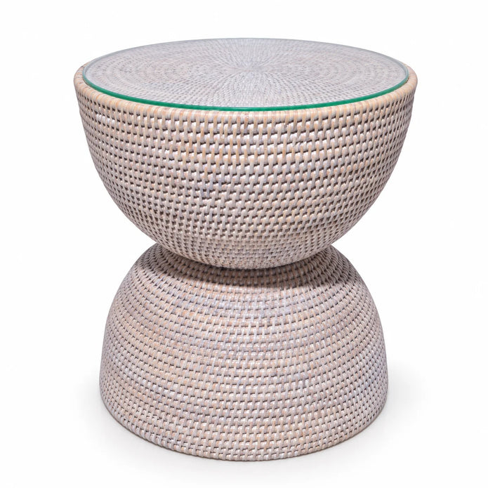 Lows Wickham rattan hourglass side table with clear glass top in white studio setting