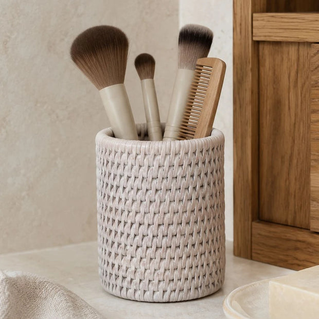 Wickham Rattan Pen Or Storage Pot, pale woven pot holding brushes and a comb beside a mirror