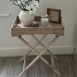 Lows rattan rectangle tripod side table with wooden legs, modern furniture piece for living room or patio decor.