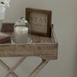 Lows rattan rectangle tripod side table with wooden legs and woven rattan surface, ideal for living room or bedroom decor.