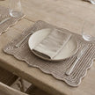 Wickham Rattan Rectangle Scalloped Placemats - Set of Two, close-up of a scalloped placemat beneath a plate and linen napkin