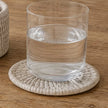 Wickham Rattan Round Coaster Set & Holder, close-up of a glass resting on a pale woven coaster