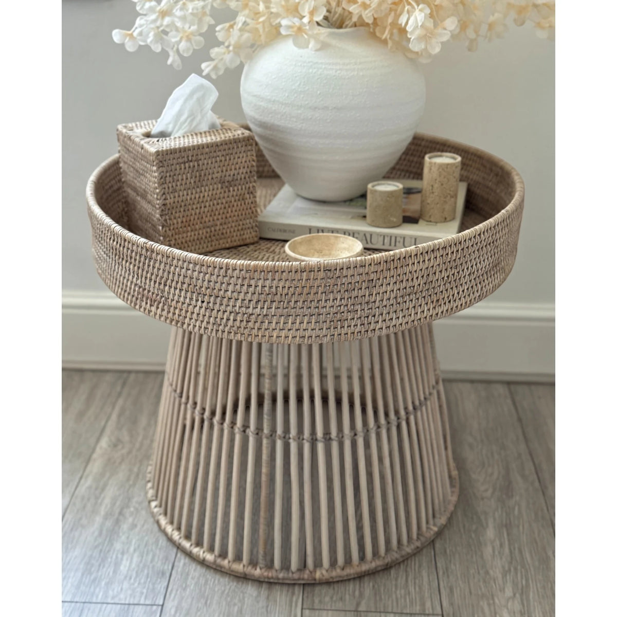 Lows rattan round side table with woven surface, modern furniture piece for living room or patio decor.