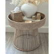Lows rattan round side table with woven surface, modern furniture piece for living room or patio decor.