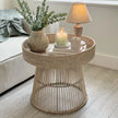 Lows rattan round side table with woven design, ideal for living room or patio decor, showcasing natural rattan material.