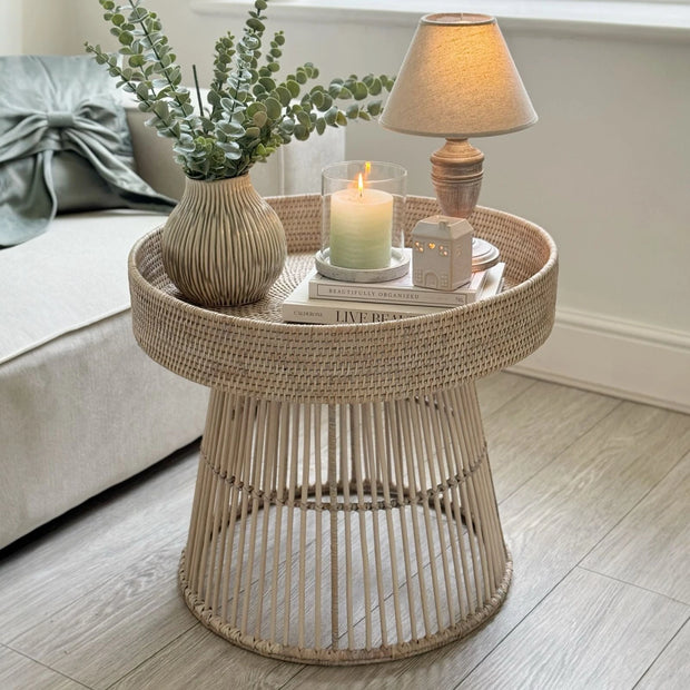 Lows rattan round side table with woven design, ideal for living room or patio decor, showcasing natural rattan material.
