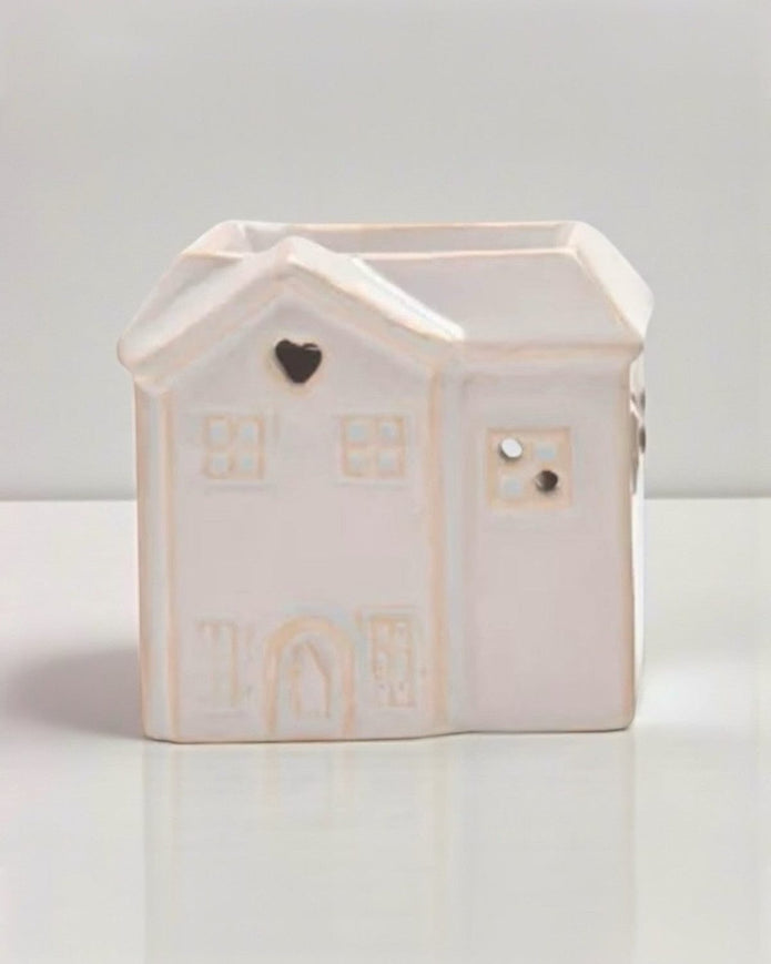 Small beige ceramic house wax burner by Widdop & Co, decorative home fragrance accessory with a cozy house design.