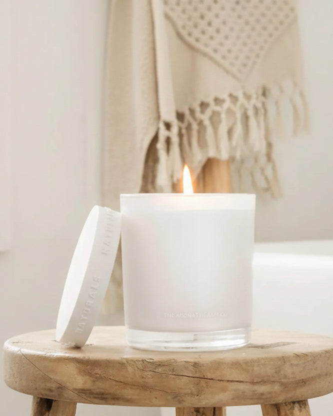 Luxury glass lidded candle by Widdop & Co featuring Neroli and Amber Wood scent, with a clear glass container and elegant lid.