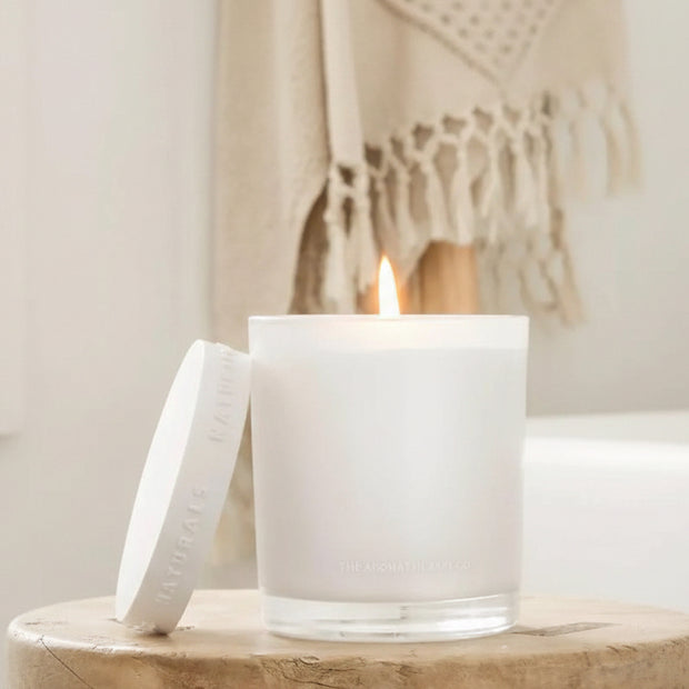 Luxury glass lidded candle by Widdop & Co featuring Neroli and Amber Wood scent, with a clear glass container and elegant lid.