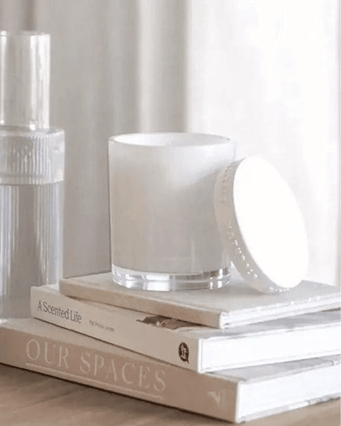 Naturals luxury glass lidded candle by Widdop & Co featuring rose, jasmine, and oud scent with a clear glass container and elegant lid.