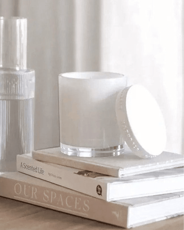 Naturals luxury glass lidded candle by Widdop & Co featuring rose, jasmine, and oud scent with a clear glass container and elegant lid.