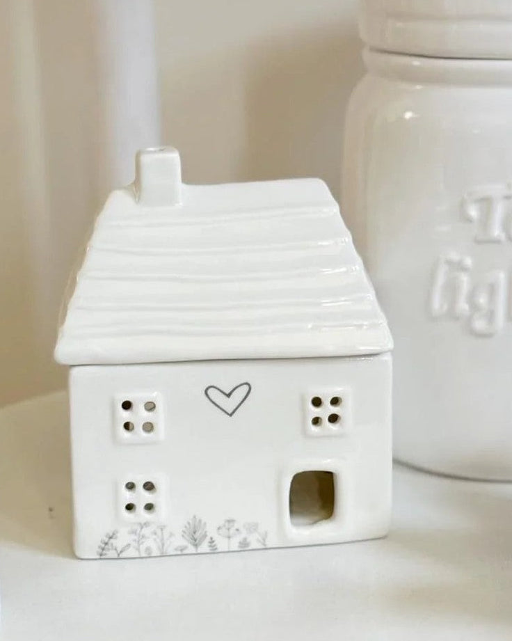 Beige ceramic house oil burner by Widdop & Co, decorative gift item with detailed house design for aromatherapy use.