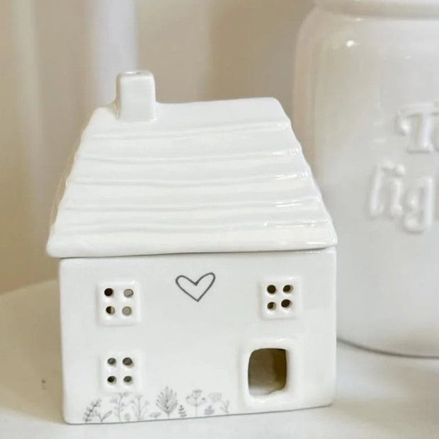 Beige ceramic house oil burner by Widdop & Co, designed for aromatherapy and decorative home scenting.