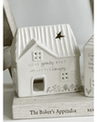 Beige ceramic house tea light holder from Widdop & Co's Moments Little Houses home décor collection, featuring a cozy house design.