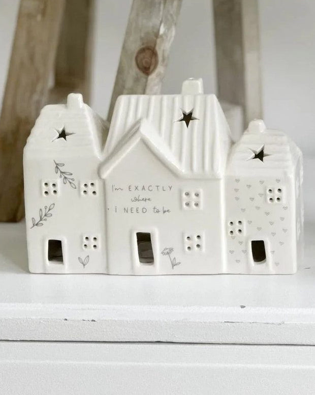 Beige ceramic house-shaped tea light holder from Widdop & Co, featuring a cozy home décor design with a warm, inviting appearance.