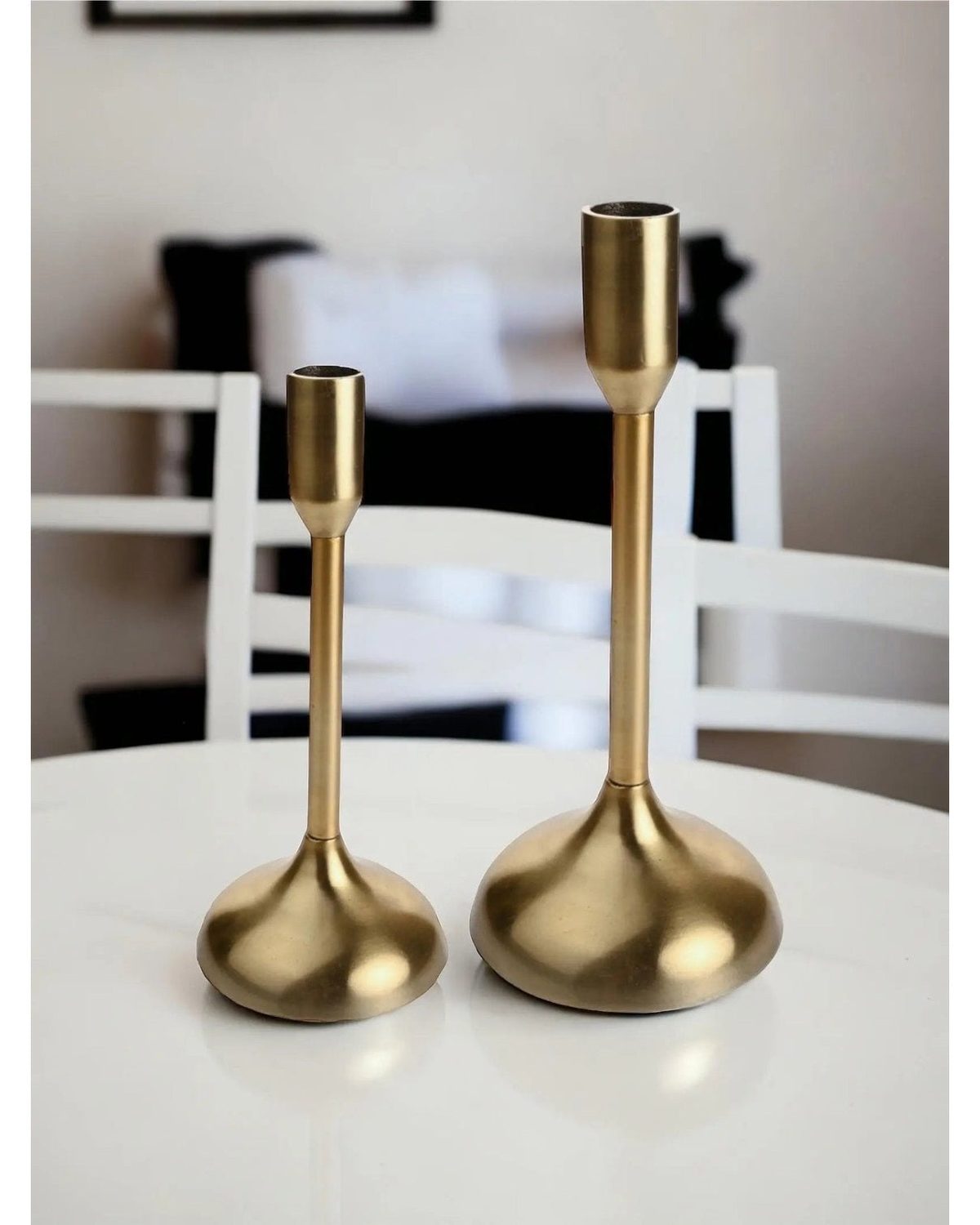 Gold metal candlestick holder from Widdop & Co, decorative home decor piece with a sleek, modern design.