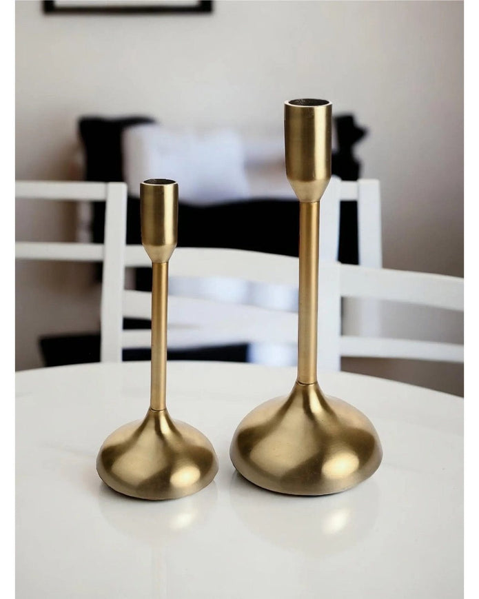 Gold metal candlestick holder from Widdop & Co, decorative home decor piece with a sleek, modern design.