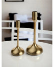 Gold metal candlestick holder from Widdop & Co, decorative home decor piece with a sleek, modern design.