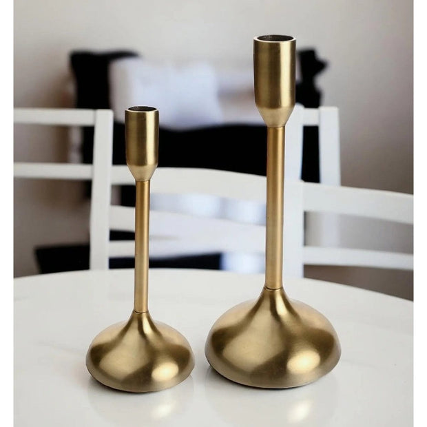 Gold metal candlestick holder from Widdop & Co, decorative home decor piece with a sleek, modern design.