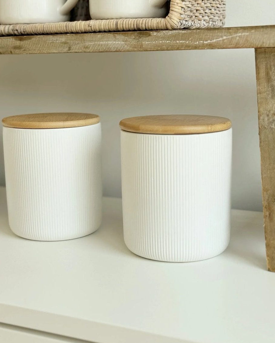 White ceramic ribbed storage jar with wooden lid from Widdop & Co, ideal for kitchen and dining organization.