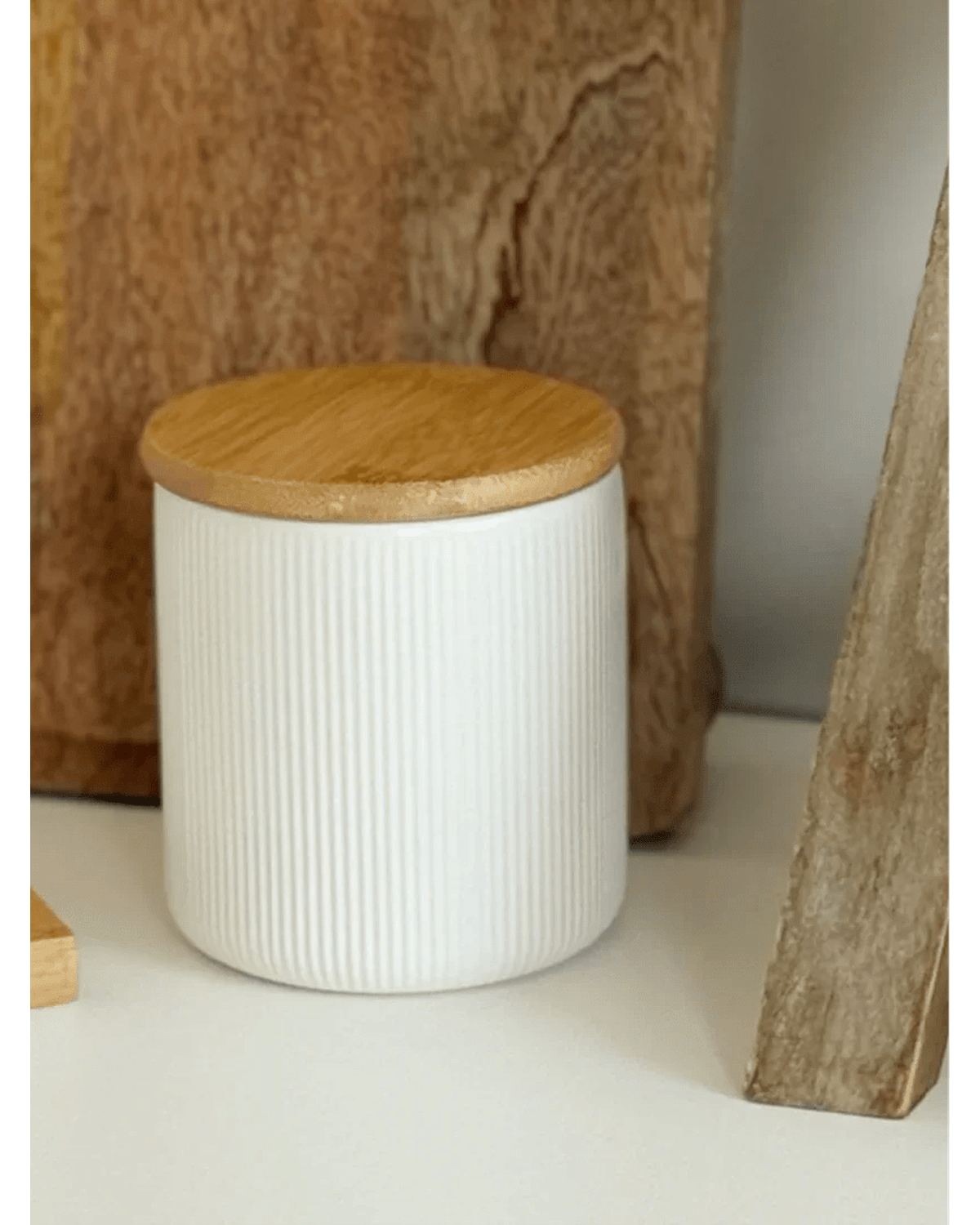 White ceramic ribbed storage jar with wooden lid, ideal for kitchen and dining organization by Widdop & Co.