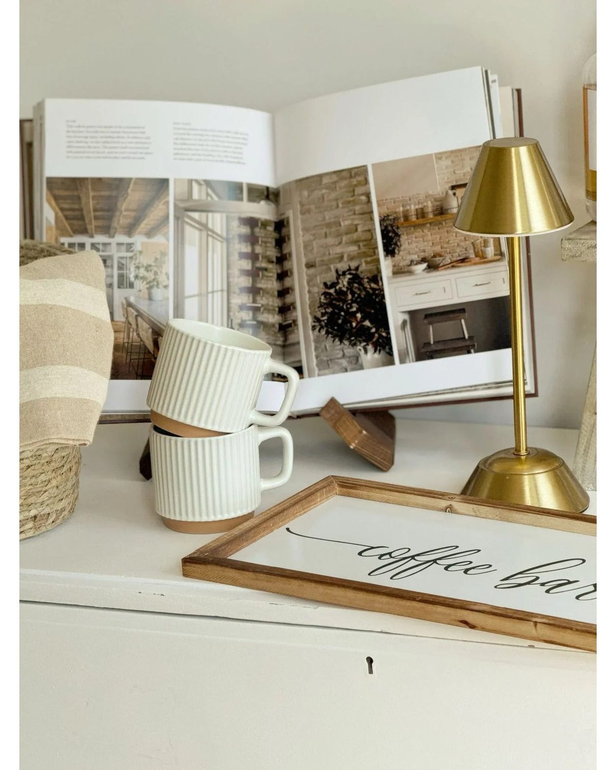 Widdop & Co LED touch desk lamp in gold with a medium-sized adjustable lighting base on a desk surface