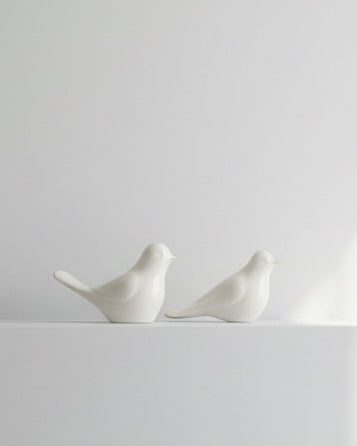 Set of two decorative bird ornaments by Wikholmform for home décor, featuring detailed craftsmanship and natural bird designs.