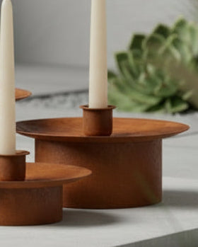 Set of three large rusty metal dinner candlestick holders for home décor by Wikholmform, featuring a vintage, industrial style.