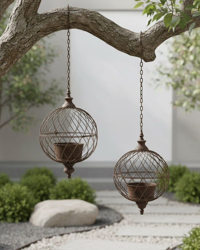 Rusty metal hanging ball planters by Wikholmform, outdoor decor with weathered textured metal design for garden display.