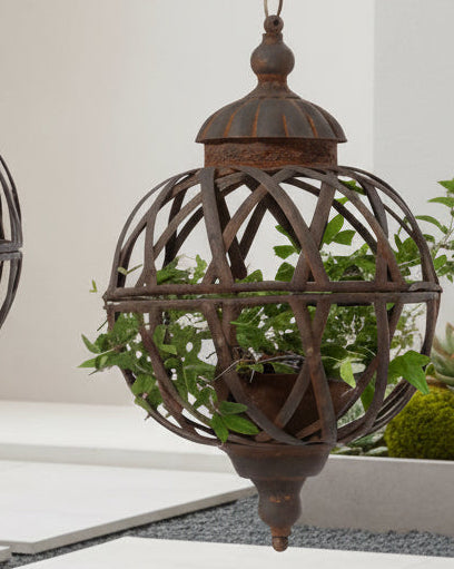 Small hanging metal rusted lattice ball planters for outdoor decor by Wikholmform, featuring a weathered, decorative design.